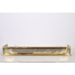 A BRASS FENDER with pierced frieze 20cm (h) x 162cm (w) x 42cm (d)