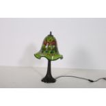AN ART DECO DESIGN TABLE LAMP the multicoloured glazed shade above a tapering column with spreading