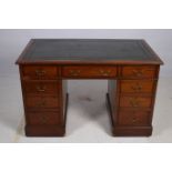 A 19TH CENTURY MAHOGANY PEDESTAL DESK of rectangular outline with tooled leather inset above three