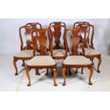 A SET OF EIGHT GEORGIAN DESIGN WALNUT DINING CHAIRS each with a scroll top rail and solid vase