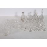 A COLLECTION OF GLASS WARE to include four cut glass decanters sherry glasses bowls etc etc on