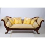 A REGENCY MAHOGANY DOUBLE SCROLL END SETTEE the curved top rail above a button upholstered panel