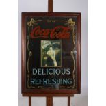 AN ADVERTISEMENT MIRROR inscribed Coca Cola Delicious and Refreshing 95cm x 69cm