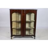 A 19TH CENTURY MAHOGANY AND POLYCHROME CHINA DISPLAY CABINET of rectangular bowed outline the