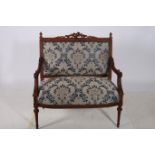 A CONTINENTAL CARVED WOOD AND UPHOLSTERED SETTEE of rectangular outline with flowerhead and foliate