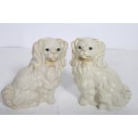 A PAIR OF STAFFORDSHIRE STYLE FIGURES modelled as King Charles Spaniels 19cm (h)