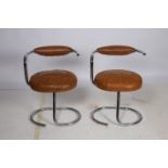 A PAIR OF RETRO CHROME AND UPHOLSTERED LOW STOOLS each with a curved top rail with upholstered