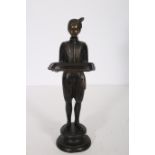 A BRONZE FIGURE modelled as a young boy holding a tray shown standing on a circular base 58cm (h)