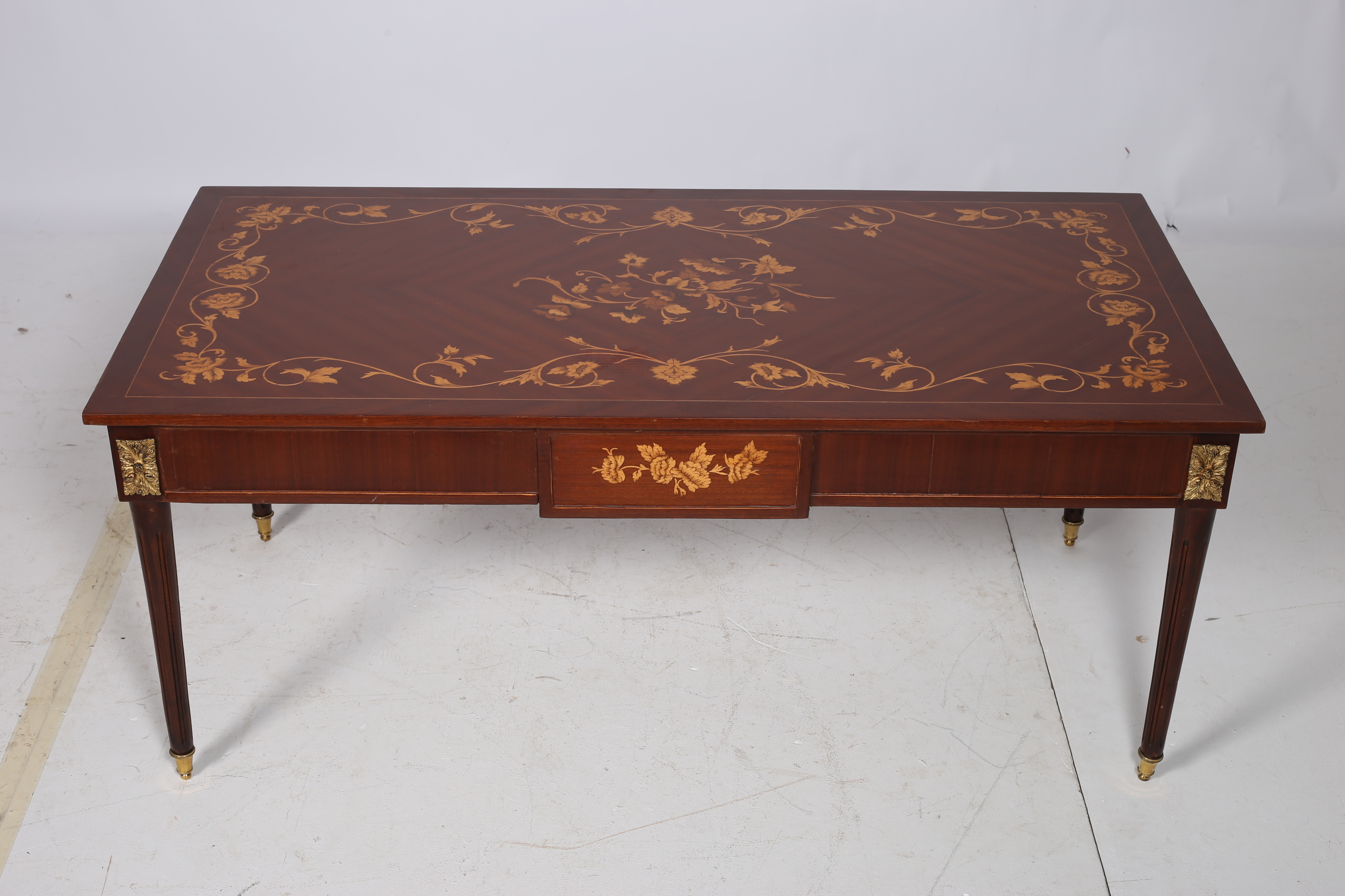 A CONTINENTAL KINGWOOD AND MARQUETRY COFFEE TABLE of rectangular outline the shaped top with