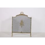 A BRASS MESH SPARK GUARD the reeded frame and laurel wreath handle with applied decoration on