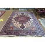 A WOOL RUG the light pink indigo and rust ground with central floral panel within a conforming