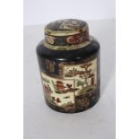 A CHINESE LIDDED JAR the black gilt and beige ground decorated with pagodas figures and foliage