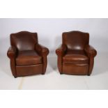 A FINE PAIR OF RETRO HIDE UPHOLSTERED ARMCHAIRS each with a shaped back and scroll over arms with