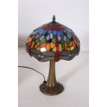 AN ART DECO DESIGN TABLE LAMP the multicoloured mushroom shaped shade above a foliate moulded