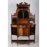 A 19TH CENTURY ROSEWOOD AND SATINWOOD INLAID SIDE CABINET of serpentine outline the superstructure