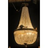 A FINE AND IMPRESSIVE CONTINENTAL CUT GLASS AND GILT BRASS BASKET CHANDELIER hung with cascading