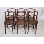 A SET OF SIX BENTWOOD CHAIRS each with a curved top rail and splat with panelled seat on tapering