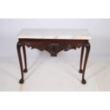 A CHIPPENDALE DESIGN MAHOGANY CONSOLE TABLE surmounted by a white veined marble top above a carved