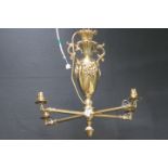 A 19TH CENTURY BRASS FOUR BRANCH CHANDELIER the urn shaped column with scroll decoration issuing