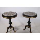 A PAIR OF CONTINENTAL EBONISED AND PARCEL GILT TABLES the circular specimen marble tops with