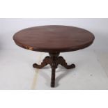 A 19TH CENTURY MAHOGANY POD TABLE the circular moulded top above a baluster column on carved tripod
