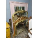 TWO GILT FRAMED OVERMANTLE MIRRORS together with an Edwardian oak framed mirror and a pink painted