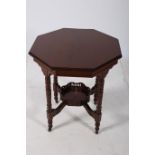 AN EDWARDIAN MAHOGANY OCCASIONAL TABLE of octagonal outline the shaped top raised on ring turned
