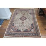 A TABRIZ WOOL RUG the beige ground with central panel filled with flowerheads palmettes and hooks