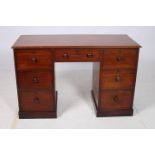 A 19TH CENTURY MAHOGANY DESK of rectangular outline the shaped top above one long and six deep