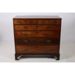 A GEORGIAN MAHOGANY AND SATINWOOD INLAID CHEST of rectangular outline the shaped top with two short