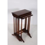 A NEST OF THREE HARDWOOD TABLES each of rectangular outline raised on dual reeded supports on