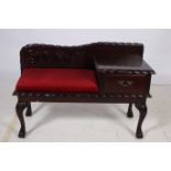 A CHIPPENDALE DESIGN MAHOGANY TELEPHONE SEAT with upholstered seat and frieze drawer on cabriole