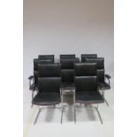 A SET OF FOUR RETRO HIDE AND CHROME ELBOW CHAIRS the panelled back and seat on moulded legs THE