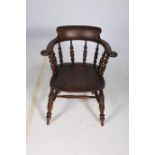 AN ELMWOOD WINDSOR CHAIR the curved back with scroll arms on spindle supports with shaped seat on