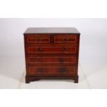 A GEORGIAN DESIGN MAHOGANY AND SATINWOOD INLAID CHEST of rectangular outline the shaped top above