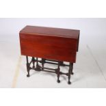 A 19TH CENTURY MAHOGANY SUTHERLAND TABLE the rectangular hinged top on turned supports and cabriole