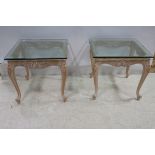 A PAIR OF LIMEWOOD AND GLAZED END TABLES each of rectangular form with plate glass top above a