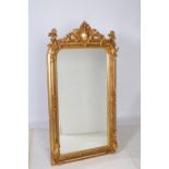 A CONTINENTAL GILT FRAME MIRROR the rectangular bevelled glass plate within a foliate and