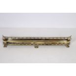 A 19TH CENTURY BRASS FENDER the roped top rail with moulded frieze with bead work decoration on