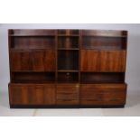 A ROSEWOOD LIBRARY SUITE comprising five open front bookcases with cupboard and five bases with