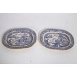 A PAIR OF IRONSTONE WILLOW PATTERN MEAT PLATTERS each of oval form 40cm (w) (AF)
