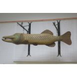A METAL AND POLYCHROME WALL MOUNTED MODEL OF A FISH suspended on two scroll wall mounted brackets