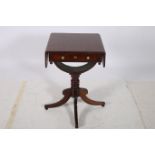 A REGENCY MAHOGANY AND ROSEWOOD CROSS BANDED DROP LEAF SIDE TABLE the rectangular hinged top with