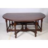 A FINE JACOBEAN DESIGN HARDWOOD DROP LEAF TABLE of circular outline the shaped top raised on square