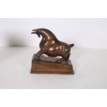 A BRONZE FIGURE modelled as a bull shown charging raised on a shaped base 22cm (h) x 25cm (w) x