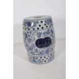 A CHINESE GLAZED POTTERY MANDARIN SEAT the blue and white ground decorated overall with flowerhead