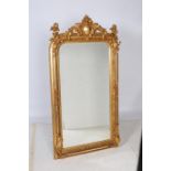 A CONTINENTAL GILT FRAME MIRROR the rectangular bevelled glass plate within a foliate and