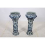A PAIR OF CONTINENTAL BLUE AND WHITE JARDINIERES ON PEDESTALS each of ovoid tapering form the white