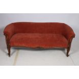 A 19TH CENTURY MAHOGANY AND UPHOLSTERED SETTEE with scroll over back and arms and carved arm