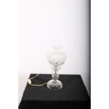 A CUT GLASS TABLE LAMP the bulbous shade above a baluster column on circular spreading foot 40cm